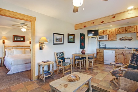 Open concept living/kitchen/dining area. Beautiful rustic log touches. 