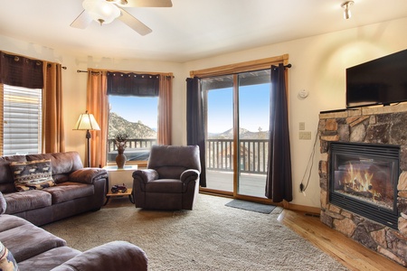 Living room with queen sleeper sofa, loveseat and recliner. Gas fireplace and flat screen TV. 