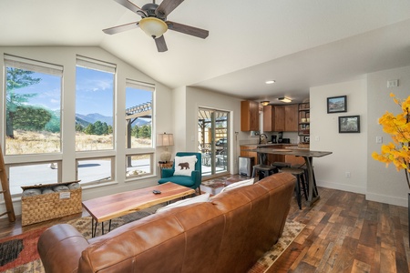 Open concept living area.  Dining table is a high top with four stools.