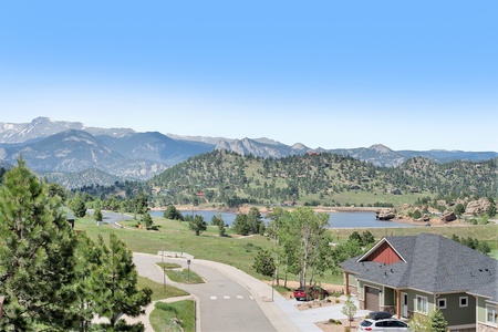 Exterior building view with views of mountains and Marys Lake. 