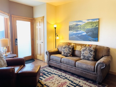 Living room with queen sleeperover, and chair with ottoman