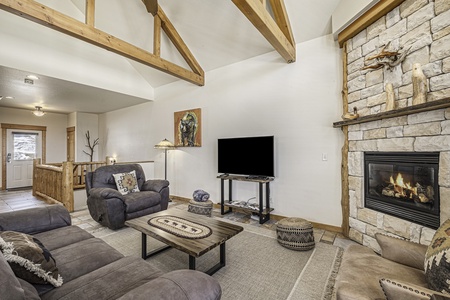 Open living space with queen sleeper sofa and comfy oversized chair. 