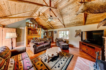 Family room with a couch that seats three, a loveseat that seats two and an overstuffed chair and ottoman 