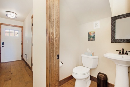 Guest bathroom near main entrance of home.