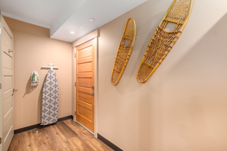 Front door inside of ADA room, with  iron and ironing board.