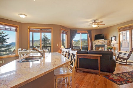 Open concept living room/kitchen with breakfast bar, dining area, fireplace and flat screen TV