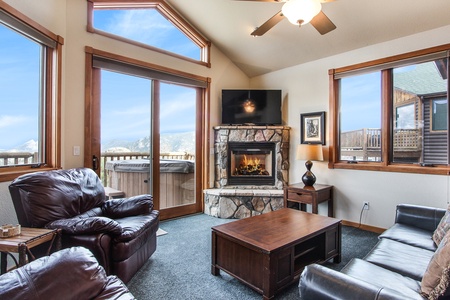 Floor to ceiling windows in the main living area allow you to take in the beautiful mountain views and comfort of the gas fireplace from either two loveseats or queen sleeper sofa.