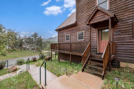 Exterior, 5 steps leading to front door with porch that wraps around to front deck.