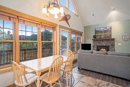 Rectangular dining table in kitchen, with seating for 6, and windows with mountain views.