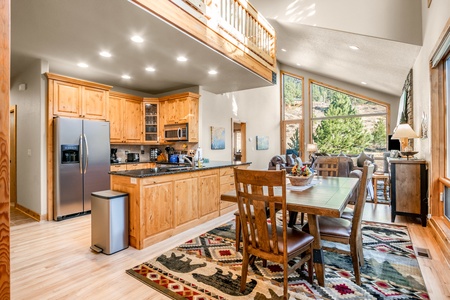 Front door opens to a large dining table area for meals or games, the open kitchen and into the living room.