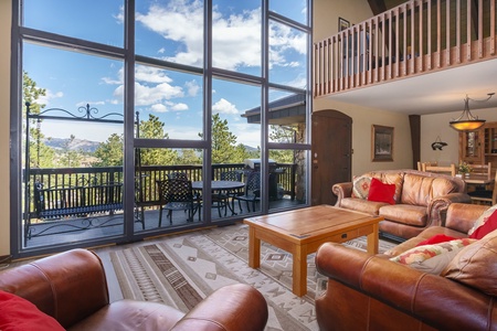 Open concept floor plan with cathedral ceiling and floor to ceiling windows. 