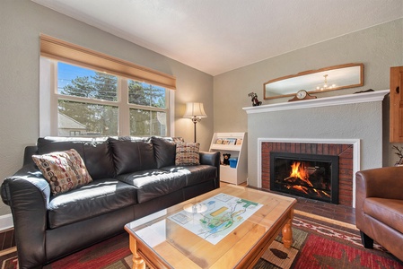 Your Vacation House Estes Park, Living room with sofa that seats 4, coffee table, and gas fireplace.