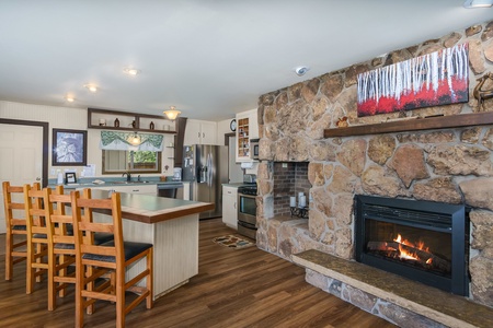 Dining/kitchen with a breakfast bar, 4 chairs and a fireplace