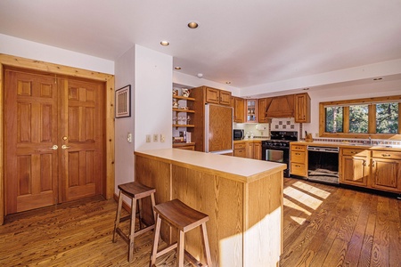 Kitchen with a breakfast bar and two bar stools