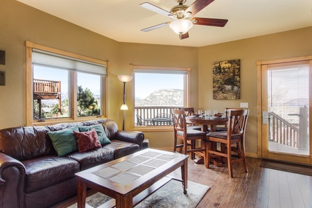 Enjoy the natural and gorgeous mountain views from the combo living/dining area, equipped with a comfortable queen sleeper sofa and bar-height table with seating for four.