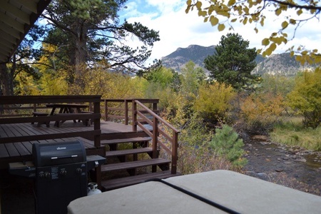 Deck features a BBQ grill and picnic table for outdoor dining during the summer months