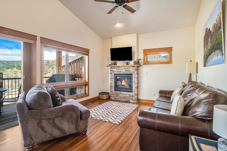 Bright, open living space with queen sleeper sofa and oversized chair. Fireplace and flat screen TV