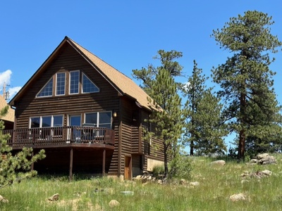 Exterior of cabin, with large deck.