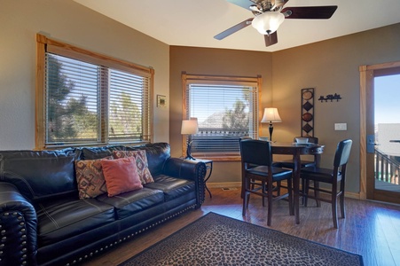 The cozy combo living/dining area has a leather queen sleeper sofa, bar height dining table with seating for 4, gas fireplace and flat screen TV.