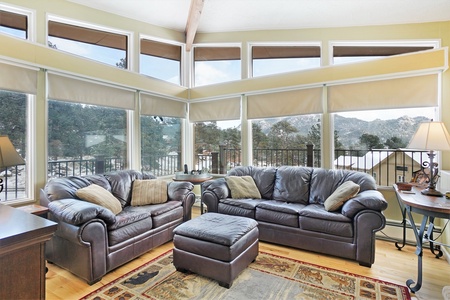 Living room with a couch, love seat, ottoman, rocking chair and spectacular views