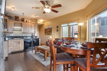 Bar-height table with seating for four in the living/dining area, adjacent to the efficiency kitchen.