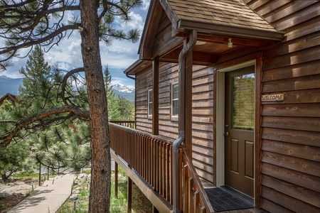 Exterior front door with porch that wraps to large deck.