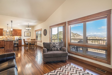 Welcome to this open living room/kitchen area with views of the surrounding mountains. 