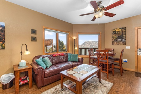 Cozy combo living/dining area with queen sleeper sofa and dining table with seating for four.