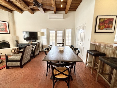 A living room with a dining table and chairs.