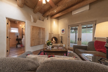 A living room with couches and a fireplace.