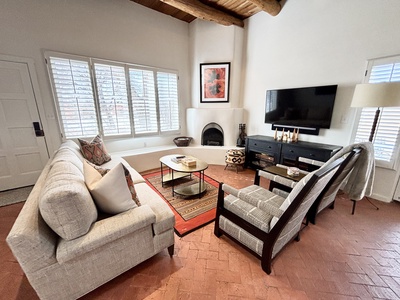 A living room with couches and a fireplace.