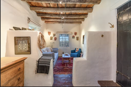 A room with wooden beams and a couch.