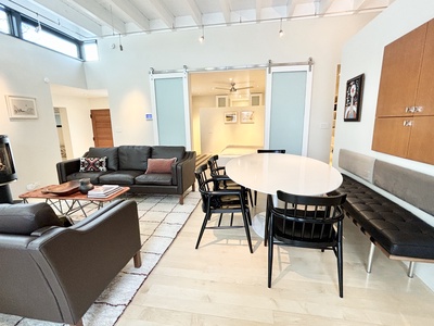 A living room with a table and chairs.