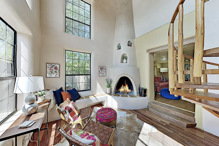 A room with a fireplace and a staircase.