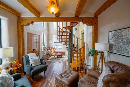 A living room with a spiral staircase.