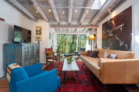 A living room with a couch and blue chairs.