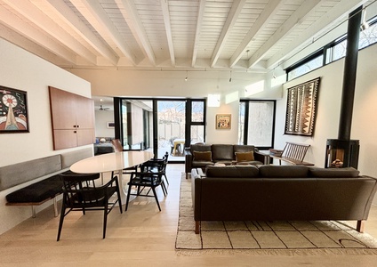 A living room with a table and chairs.