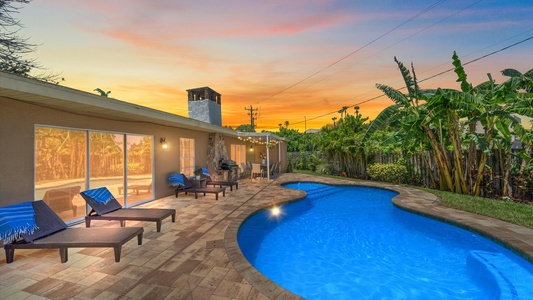 Beautiful pool with sun loungers, outdoor grill and dining area