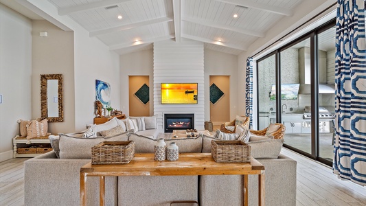 Vaulted ceilings create a bright, coastal, airy ambiance throughout, while the great room offers ample space for gatherings and reunions.