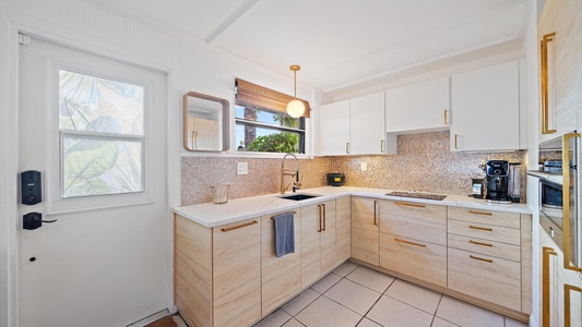 Cook at home in the fully equipped kitchen with modern appliances and coastal-inspired design.