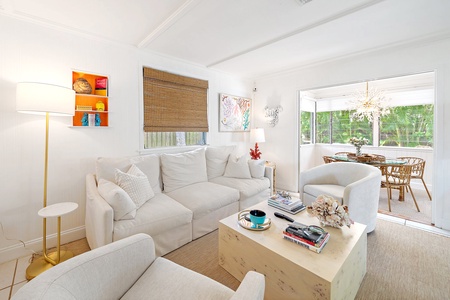 Main living room, open and airy with access to dining room with views of the outdoor private patio and seating area.