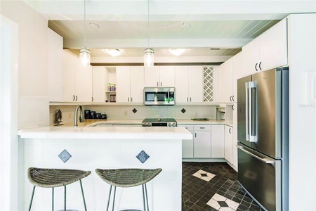 Kitchen Kitchen Updated kitchen with counter and stools.