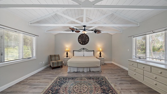 Primary Bedroom with Large Windows for Natural Lighting and a California King bed flanked by nightstands with lamps