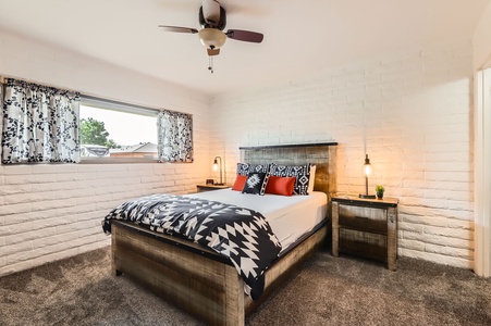 Primary bedroom with comfortable Queen and ceiling fan