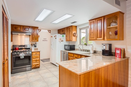 Well appointed kitchen has all you need to dine in.