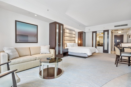 A spacious room featuring a queen sized sofa bed and a king size bed