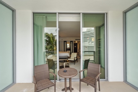 Balcony with two wicker chairs and a round table