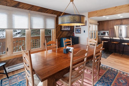 Another view of the dining room with kitchen in the background.