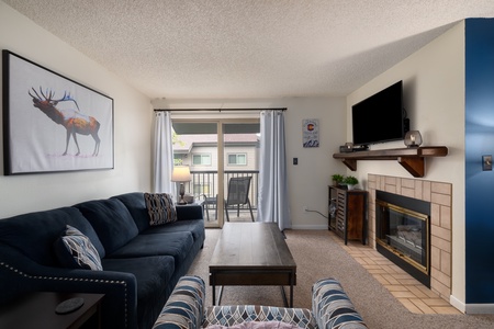 View of living room with line of sight to the balcony, which has two chairs