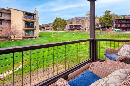 Patio furniture, balcony, mountain view.